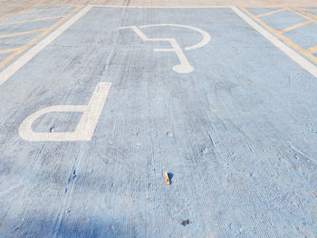 High angle view of arrow sign on road in city