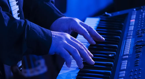 Midsection of man playing piano