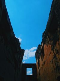 Low angle view of old building against blue sky