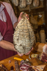 Delicious culatello in the hands of the butcher.