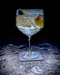 Close-up of drink on table against black background