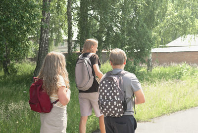 Rear view of a friends looking at trees