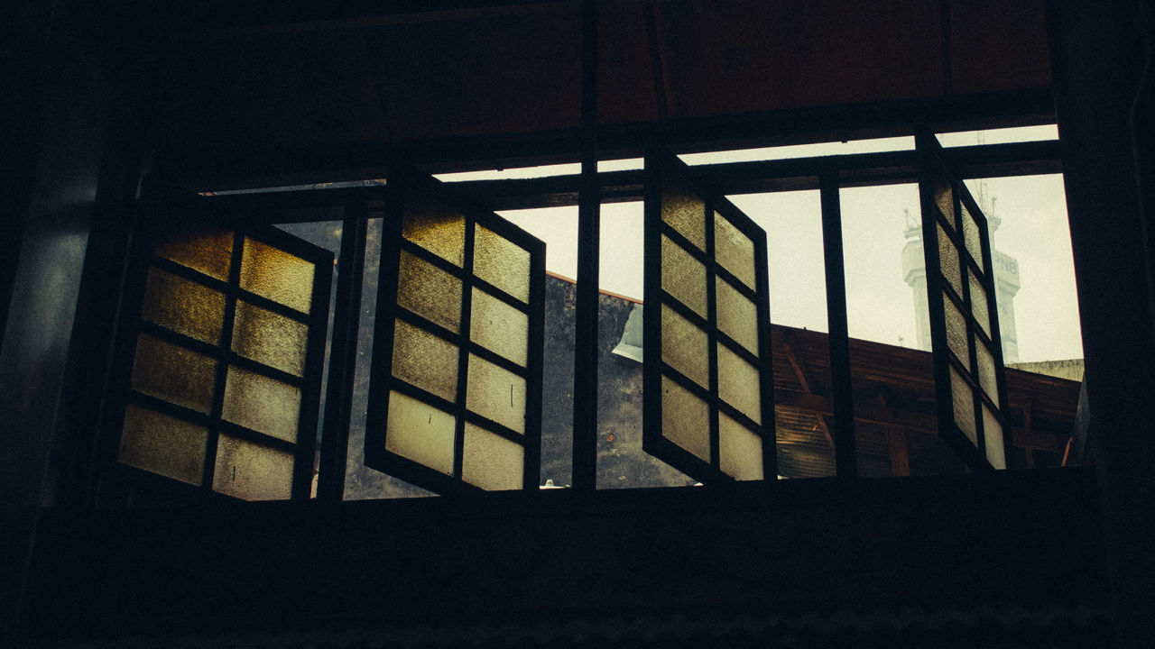 LOW ANGLE VIEW OF HOUSE SEEN THROUGH WINDOW OF BUILDING