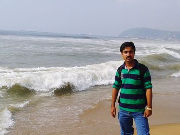 Full length of man standing on beach