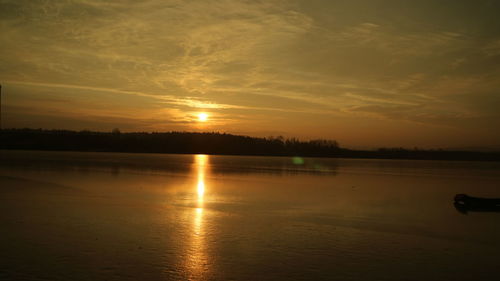 Scenic view of lake against sky during sunset