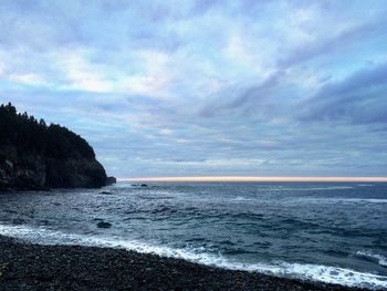 Scenic view of sea against cloudy sky