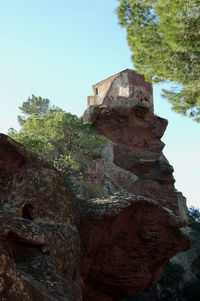 Low angle view of rock formation against sky