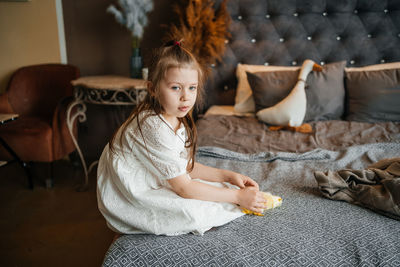 Little girl playing on the bed. high quality photo