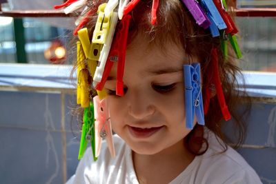 Close-up of girl with clothespins in hair