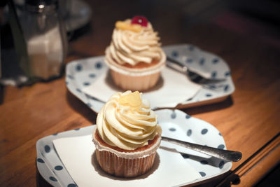 Cupcakes in trays on table