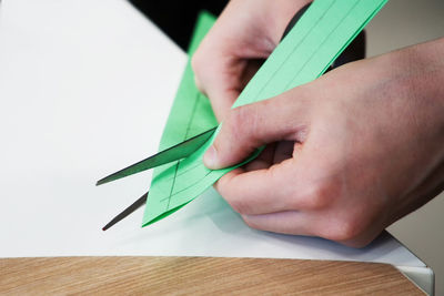 Close-up of human hand holding paper