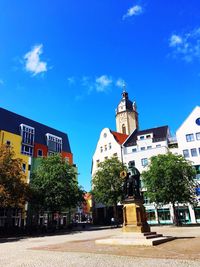 Low angle view of buildings against blue sky