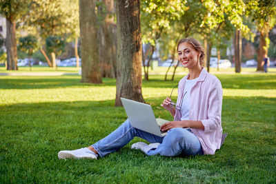 Woman using mobile phone in park