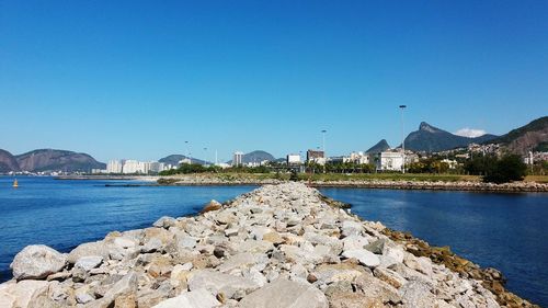 Scenic view of lake against clear blue sky