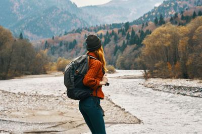 Rear view of man walking on mountain road