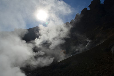 Hot steam vapors rising off of active geothermal area in hveragerdi iceland.