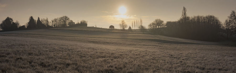 Scenic view of land against sky during sunset