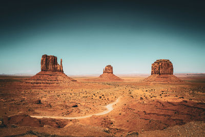 Rock formations on mountain against clear sky