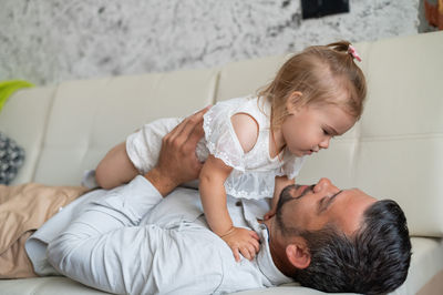 Father and son baby on bed