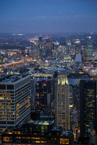 Illuminated cityscape against sky at night