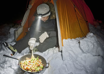 Preparing dinner at a wintercamp on the langjokull glacier in iceland