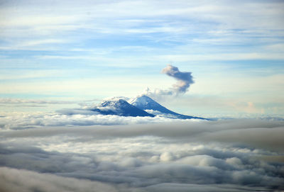 Scenic view of volcanoes amidst cloudscape