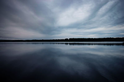 Scenic view of lake against sky at dusk