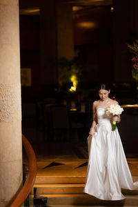 Rear view of young woman standing against blurred background