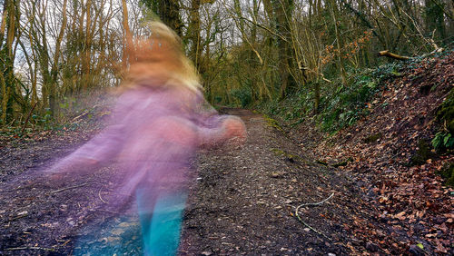 Blurred motion of man in forest