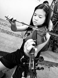 Girl playing violin at home