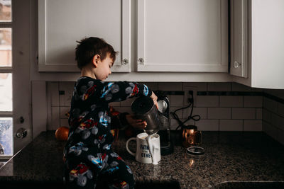 Boy photographing at home