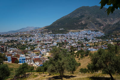 Aerial view of townscape against clear blue sky