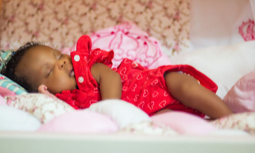Cute baby sleeping on bed