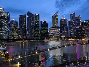 Illuminated buildings in city against sky