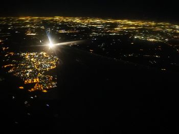 High angle view of illuminated cityscape against sky at night