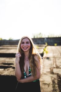 Portrait of smiling young woman standing on terrace