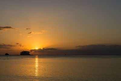 Scenic view of sea against romantic sky at sunset