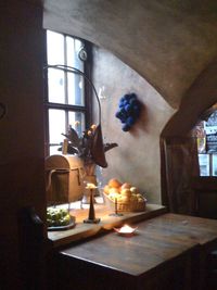 Potted plant on table by window at home