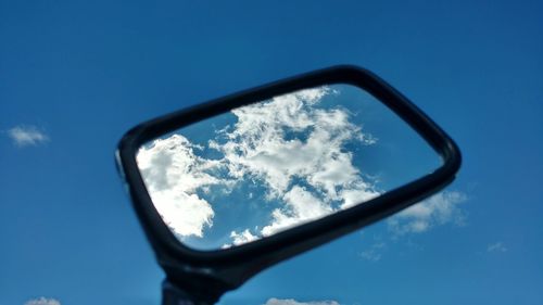 Reflection of sky on side-view mirror