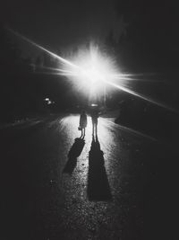 Silhouette woman walking on road