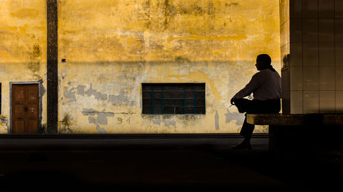 Rear view of man sitting on seat