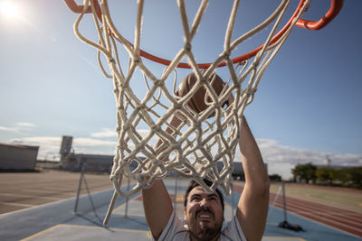 Portrait of basketball hoop against sky