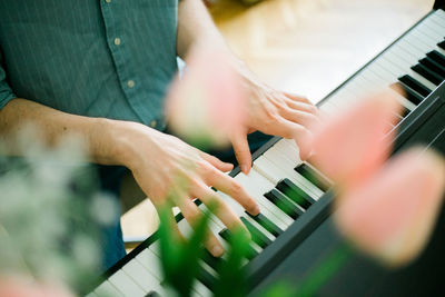 Midsection of man playing piano