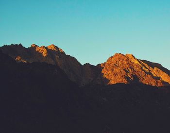 Scenic view of mountains against clear blue sky