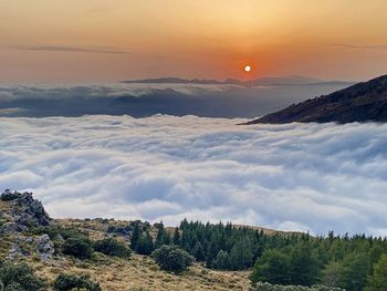 Scenic view of snowcapped mountains against sky during sunset