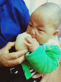 Close-up of cute baby holding hands