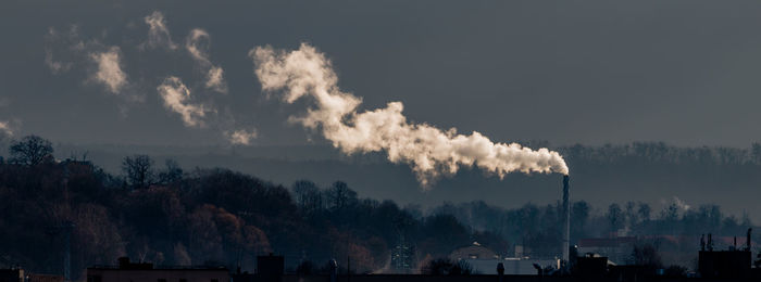 Smoke emitting from chimney against sky at night