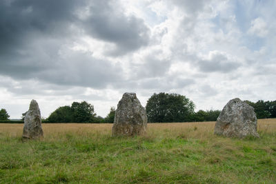 Hay bales on field against sky