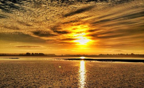 Scenic view of sea against romantic sky at sunset