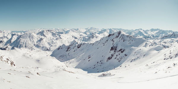 Scenic view of snowcapped mountains against clear sky